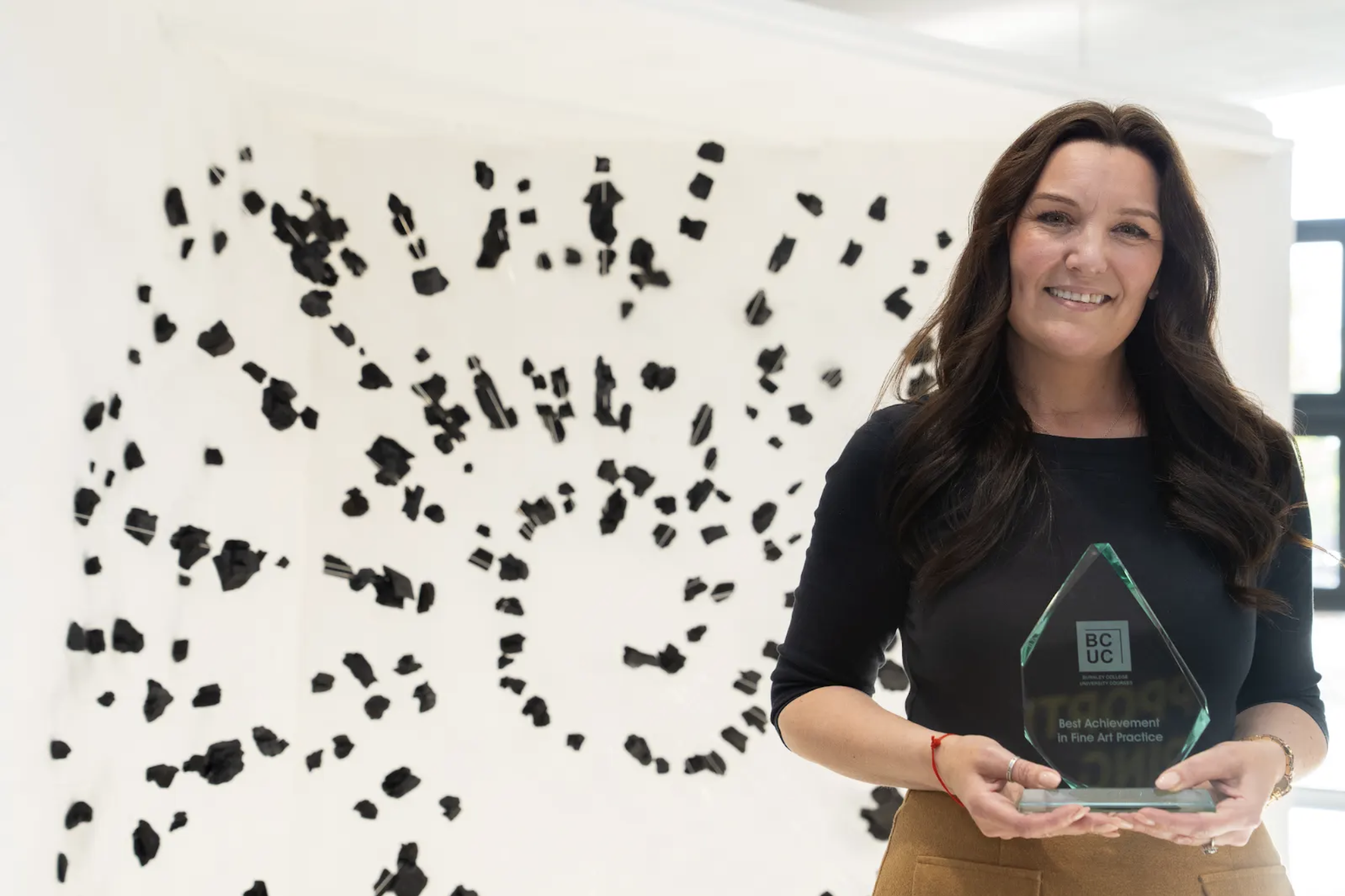 Lea Langley receiving the Best Achievement in Fine Art Practice award with Dark Matter installation, 2026